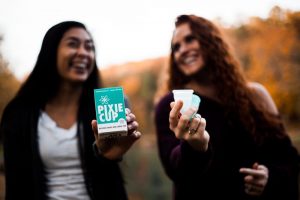 two girls holding pixie cups