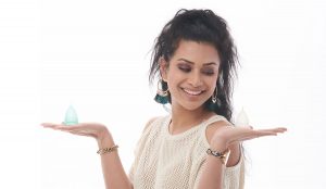 Girl holding small and large pixie menstrual cups