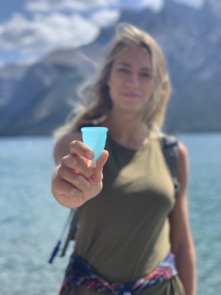 girl holding menstrual cup