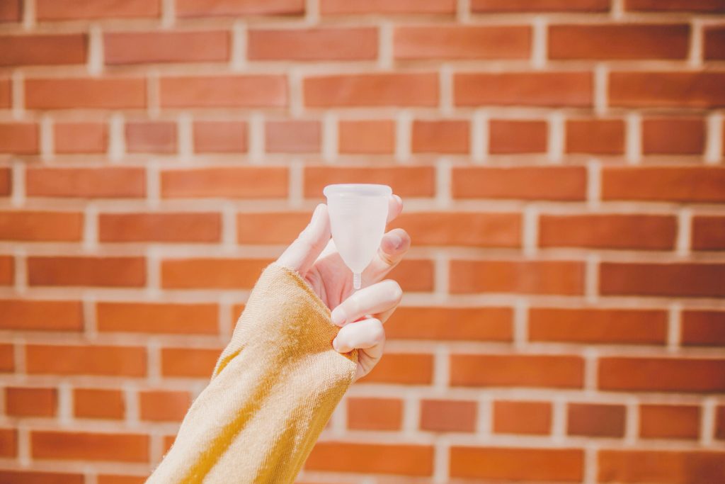 holding a menstrual cup