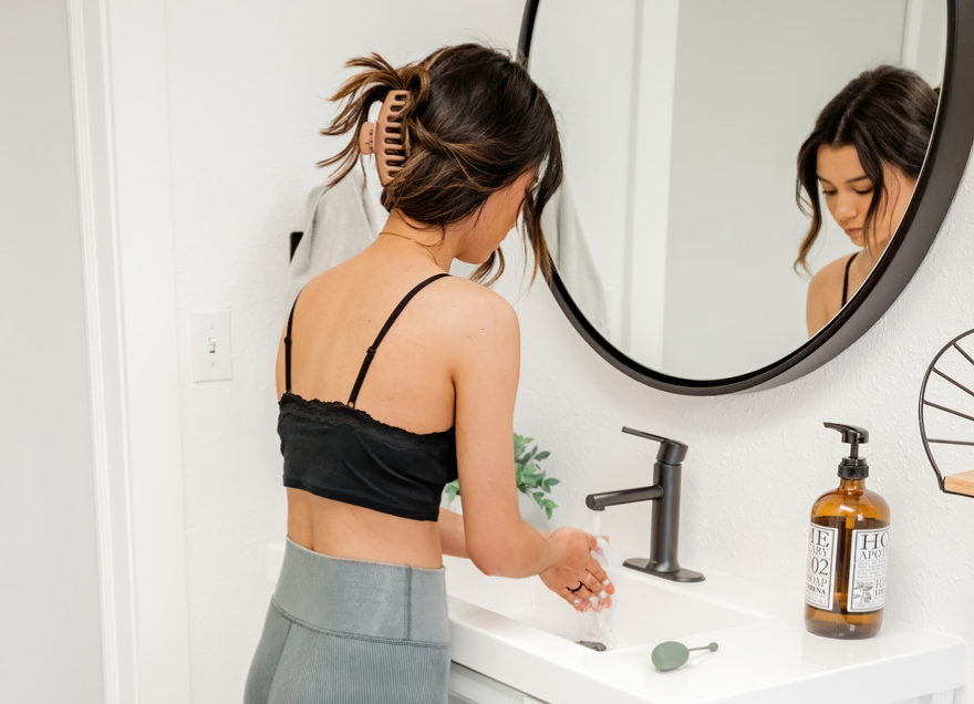 Girl washing her hands before checking her cervical height