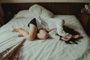woman in bed with period cramps