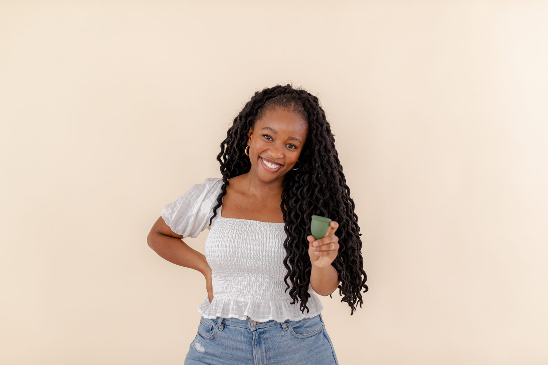 woman holding a menstrual cup