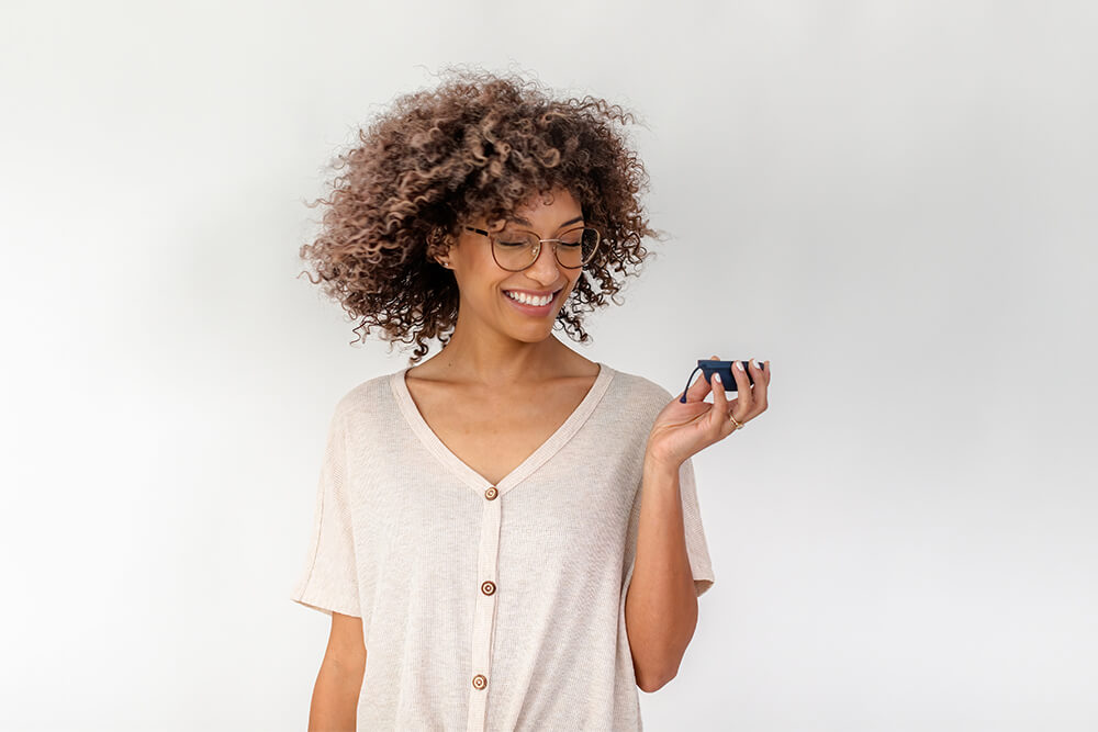 A woman holding a menstrual disc in her hand