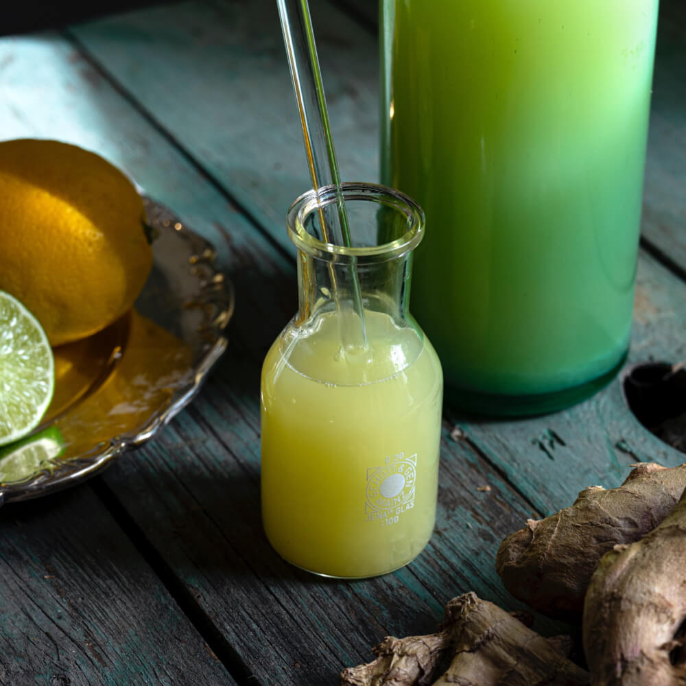 A zesty Ginger Lemonade with a hint of ginger spice, served in a chilled glass with lemon wedges.