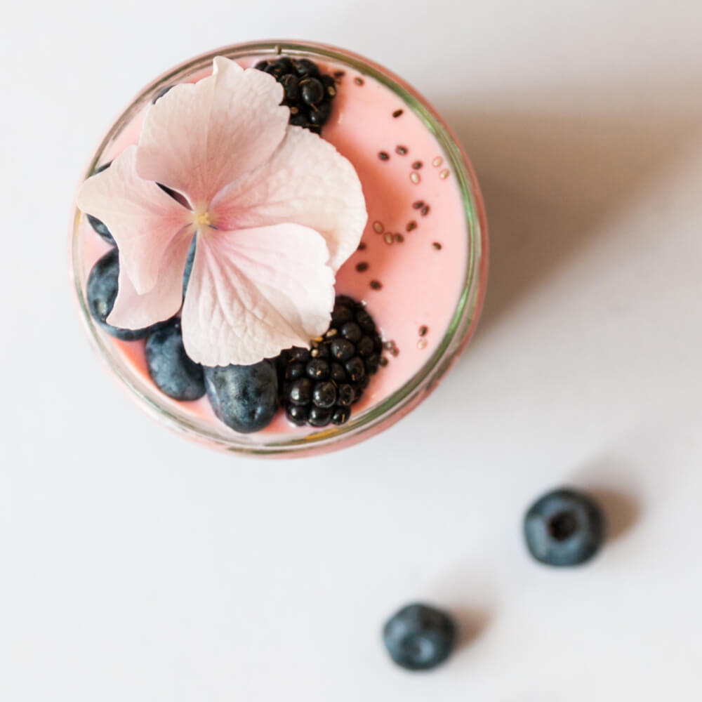 A vibrant Berry Chia Fresca served in a mason jar, showcasing layers of chia seeds, mixed berries, and sparkling water.